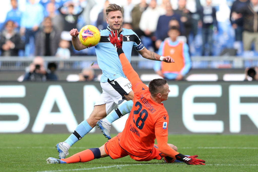 ROME, ITALY - 2020/02/29: Ciro Immobile (Lazio) kicks over Lukasz Skorupski (Bologna) during the Serie A match between SS Lazio and Bologna BFC at Stadio Olimpico in Rome, Italy. 
Lazio beat Bologna by 2-0 during the 26th round of Serie A. (Photo by Giuseppe Fama/Pacific Press/LightRocket via Getty Images)