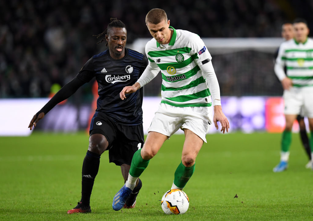 GLASGOW, SCOTLAND - FEBRUARY 27: Dame N'Doye of FC Kobenhavn challenges Jozo Simunovic of Celtic FC during the UEFA Europa League round of 32 second leg match between Celtic FC and FC Kobenhavn at Celtic Park on February 27, 2020 in Glasgow, United Kingdom. (Photo by Mark Runnacles/Getty Images)