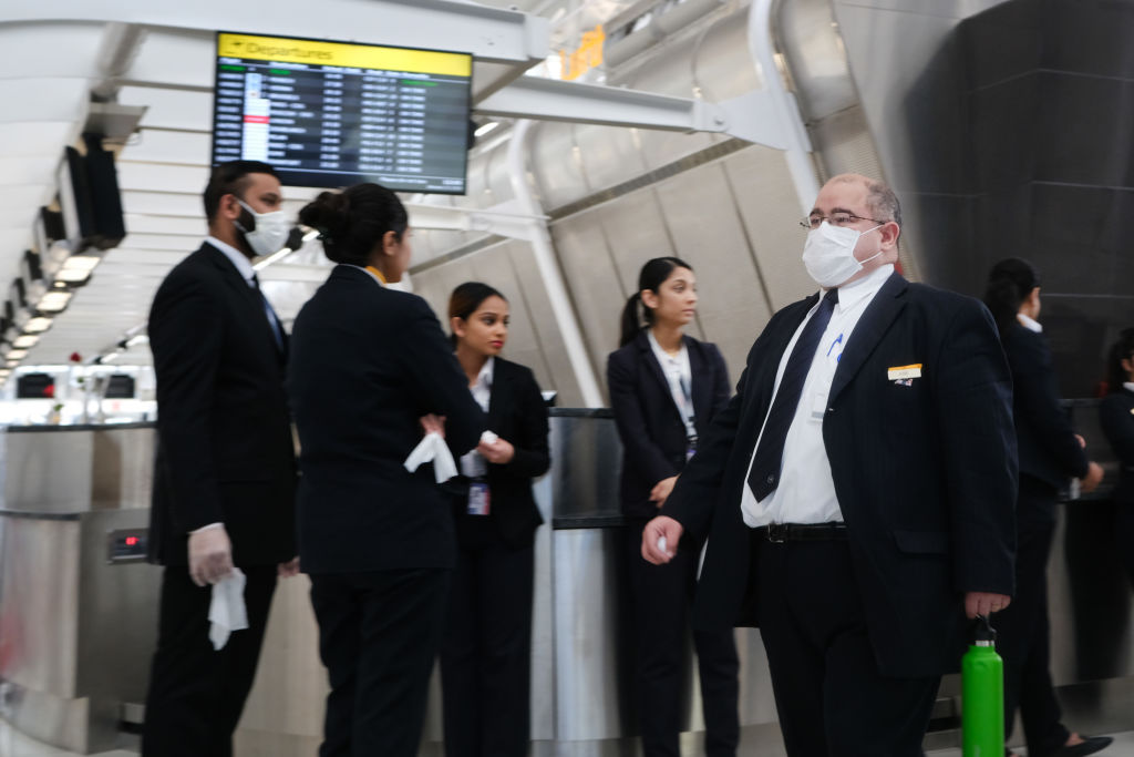 NEW YORK, NEW YORK - JANUARY 31: At the terminal that serves planes bound for China, airport employees wear medical masks at John F. Kennedy Airport (JFK) out of concern over the Coronavirus on January 31, 2020 in New York City. The virus, which has so far killed over 200 people and infected an estimated 9,900 people, is believed to have started in the Chinese city of Wuhan. (Photo by Spencer Platt/Getty Images)
