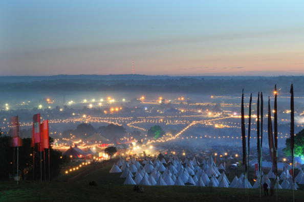 GLASTONBURY, ENGLAND - JUNE 28:  A view of the festival site from Pennard Hill at dawn during day 4 of the Glastonbury Festival at Worthy Farm in Pilton, Somerset on June 28, 2009 in Glastonbury, England.  (Photo by Jim Dyson/Getty Images)