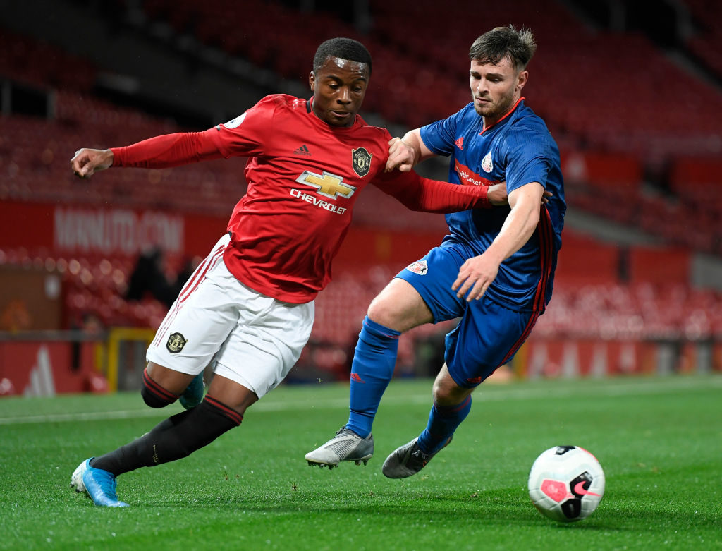 MANCHESTER, ENGLAND - NOVEMBER 22: Franck Amekortu of Sunderland U23 battles for possession with Ethan Laird of Manchester United U23 during the Premier League 2 match between Manchester United and Sunderland at Old Trafford on November 22, 2019 in Manchester, England. (Photo by George Wood/Getty Images)