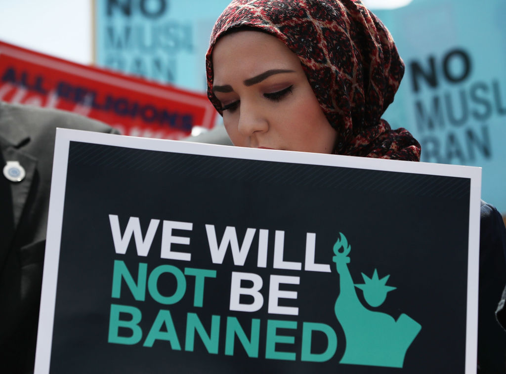 WASHINGTON, DC - JUNE 26: A women participates in demonstration against U.S. President Trump's travel ban as protesters gather outside the U.S. Supreme Court following a court issued immigration ruling June 26, 2018 in Washington, DC. The court issued a 5-4 ruling upholding U.S. President Donald Trump's travel ban imposing limits on travel from several primarily Muslim nations. (Photo by Mark Wilson/Getty Images)