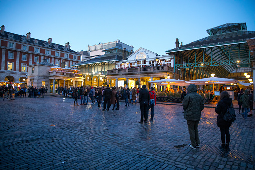 Tourist crowd at dusk in Covent Garden - London