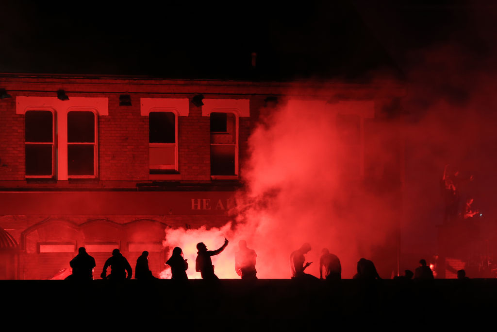 Liverpool fans celebrate outside a pub