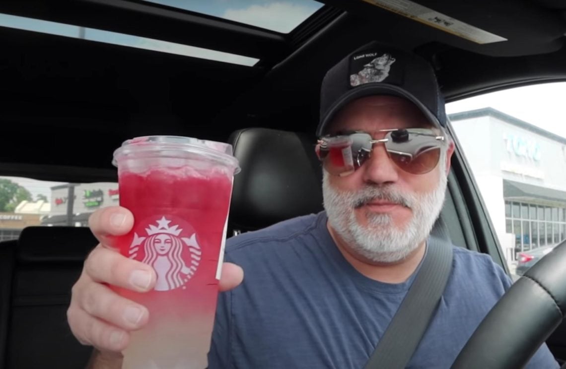 YouTuber holds up a 4th of July Firecracker drink from the Starbucks secret menu