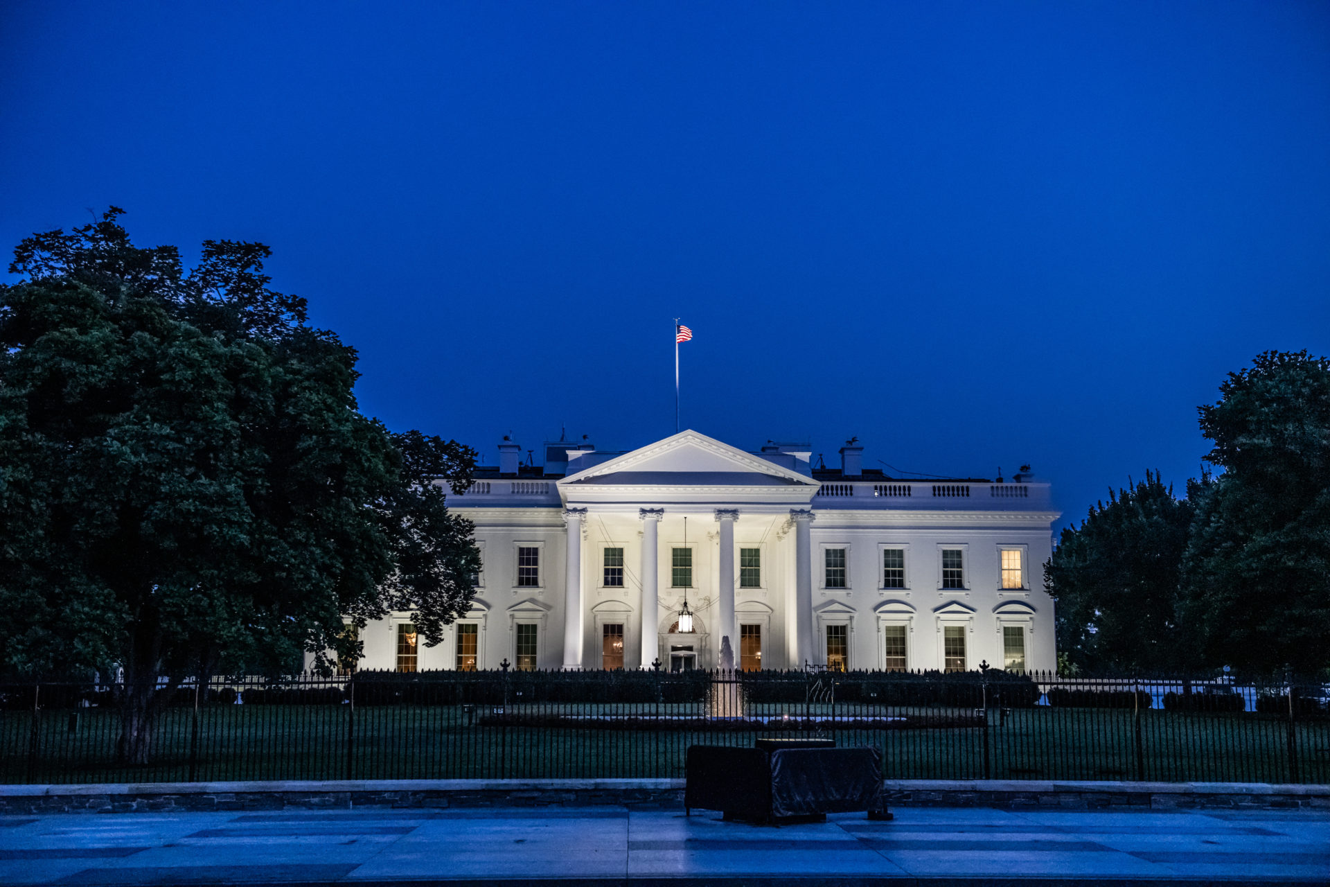 Horizontal color photo of White House in Washington DC on a clear summer evening
