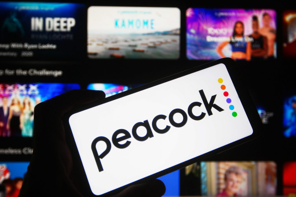 In this photo illustration a Peacock logo of an US video...