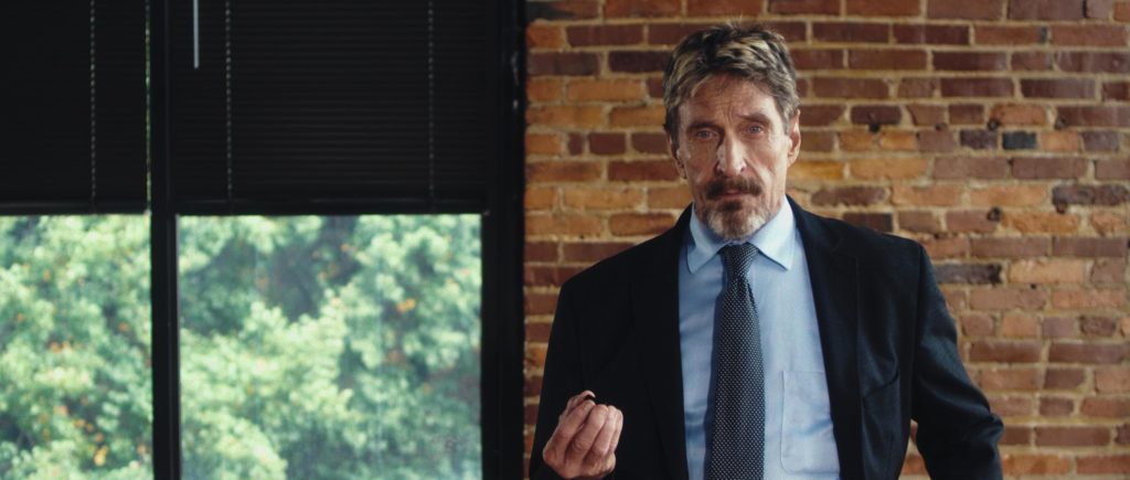 John McAfee looks to camera in still from Running With the Devil
