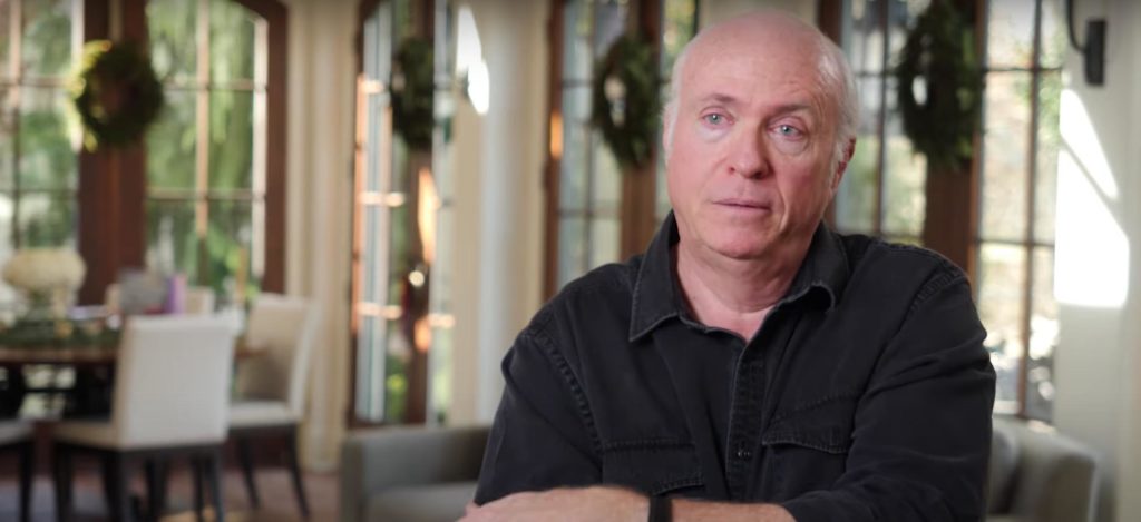 Medium shot of Tom Griswold in a black shirt talking about his daughter Finn in a video produced by Riley Kids Hospital 