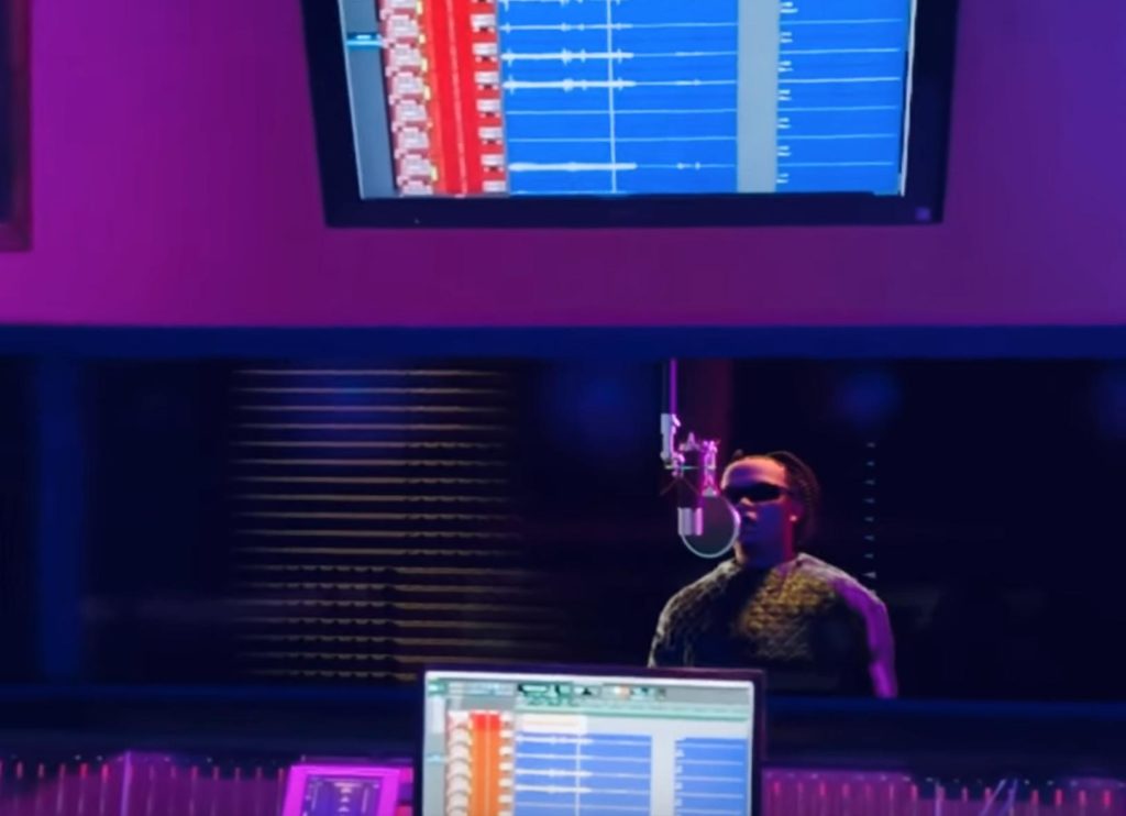 Virtual rapper FN Meka in the studio, singing into a mic