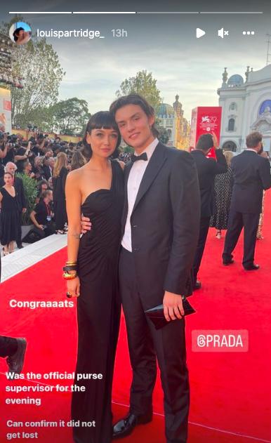 Sydney Chandler and Louis Partridge pose together on the red carpet at the Venice Film Festival premiere of Don't Worry Darling