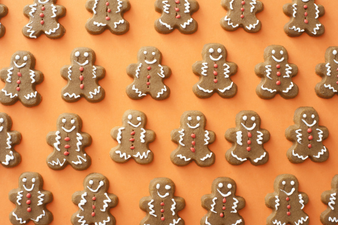 Full frame shot of gingerbread cookies on orange background