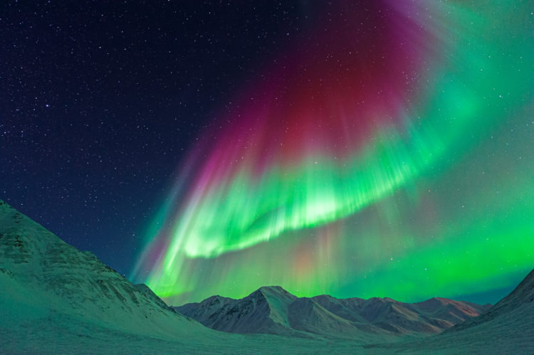 Solar storm flare rips through Earth's magnetic field with rare pink aurora