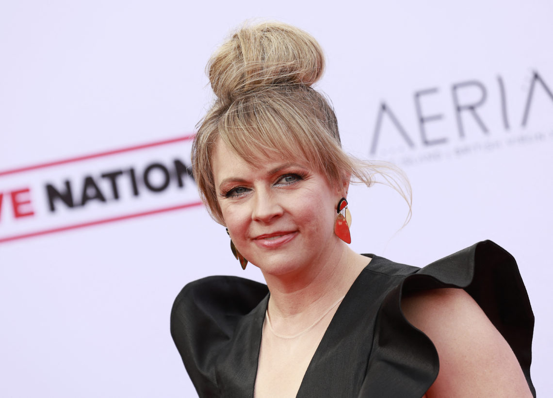 Melissa Joan Hart pictured at the Steven Tyler 4th annual Grammy Awards viewing party in April 2022, with her up in a bun and wearing red earrings