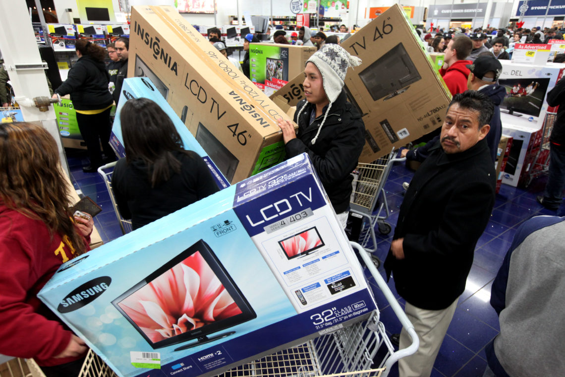 Black Friday shoppers with LCD TVs in their trolleys head for the checkouts
