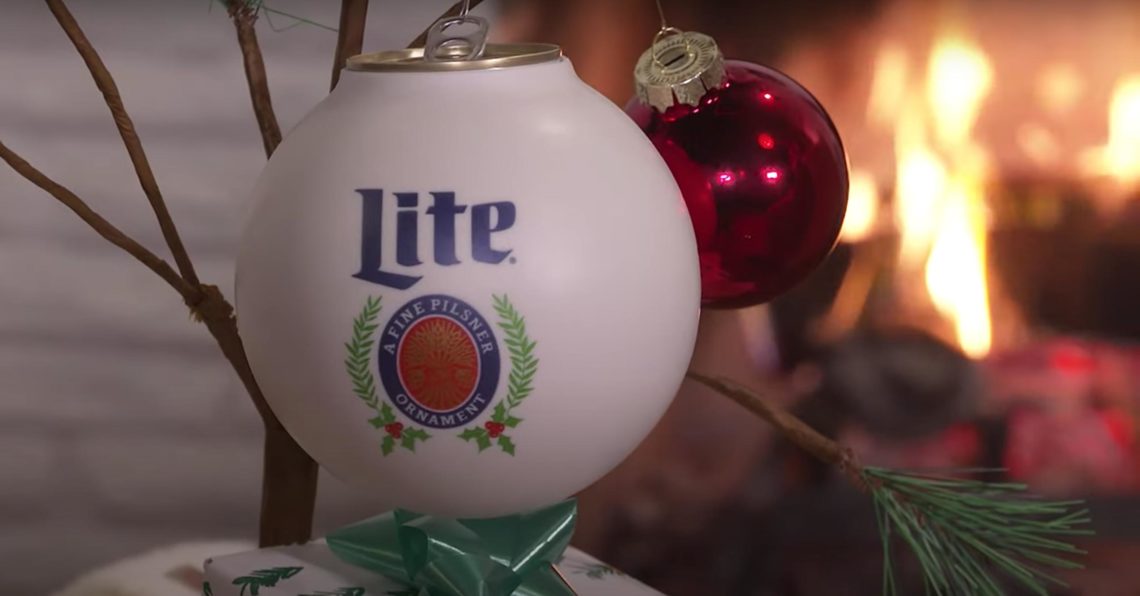 A Miller Lite beernament hangs from a small sparse tree