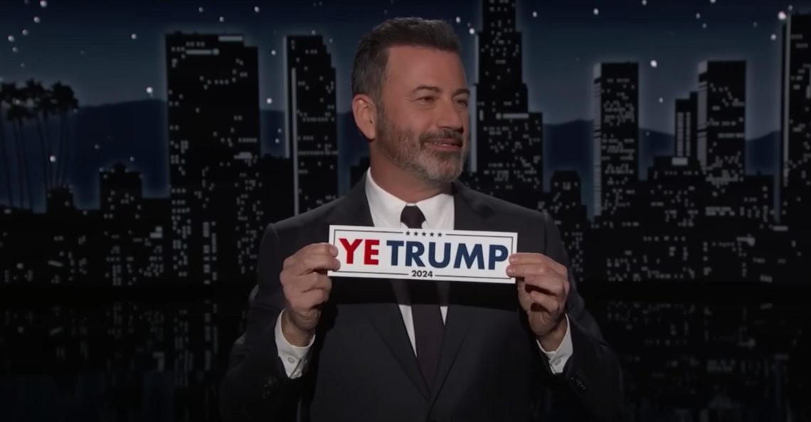 Jimmy Kimmel holds up a mockup version of a "YE TRUMP" bumper sticker during his opening monologue