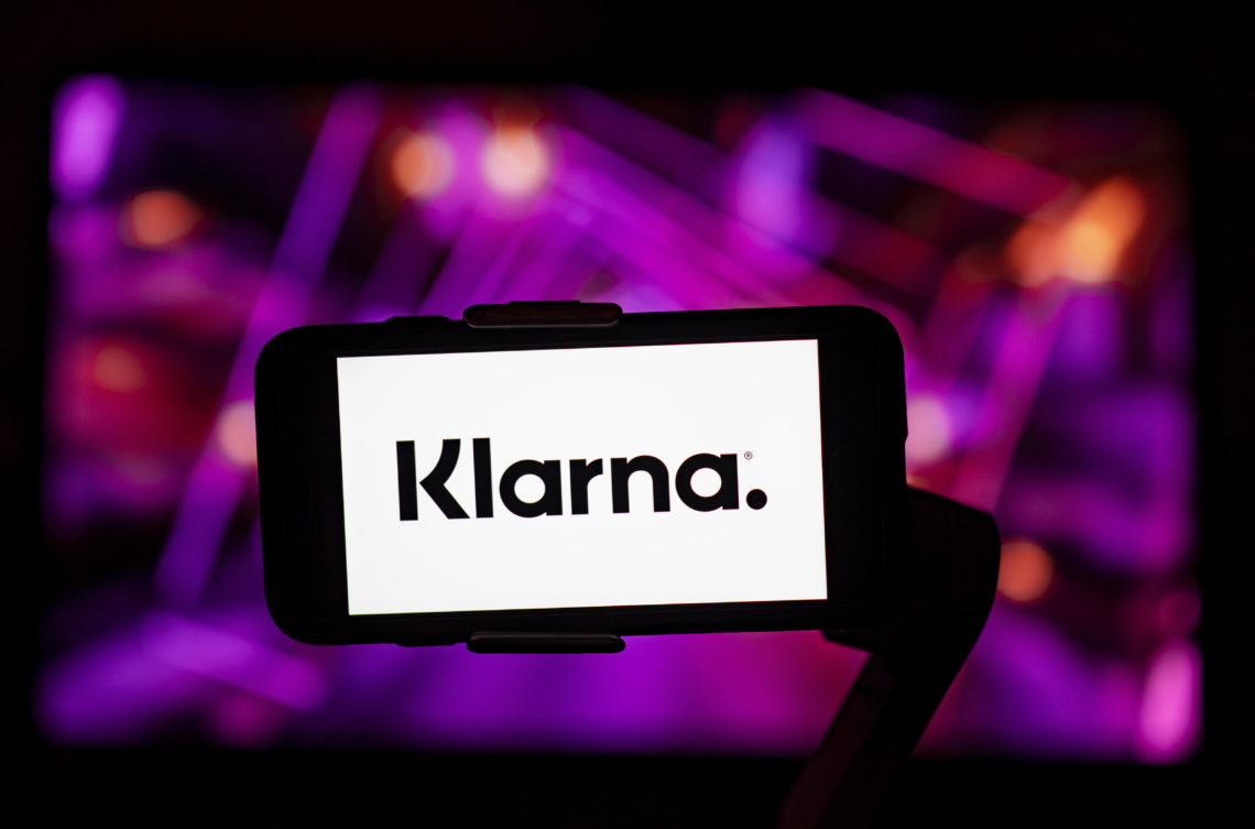 In the photo illustration, Klarna logo is seen displayed on