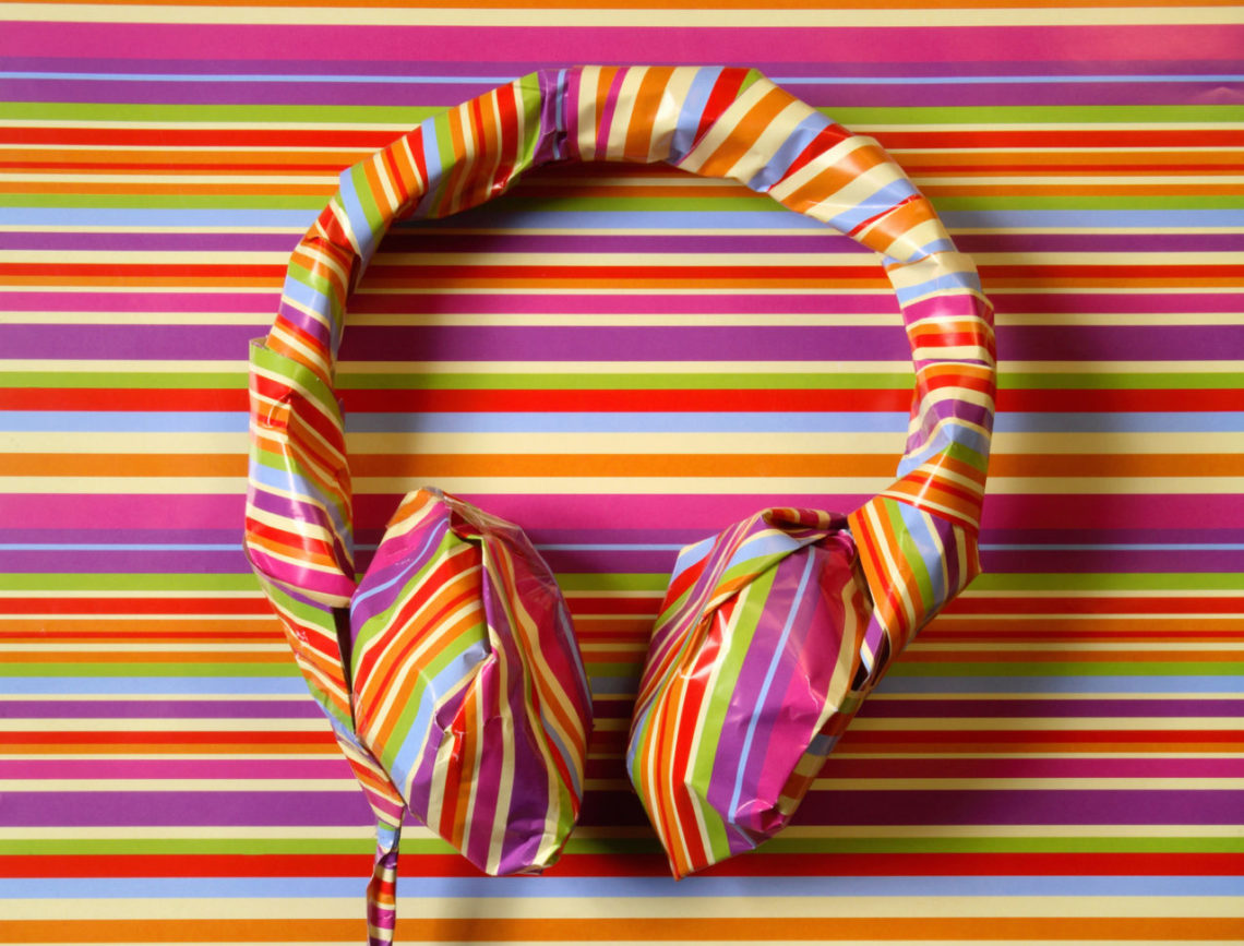 Headphones in colorful striped wrapping paper