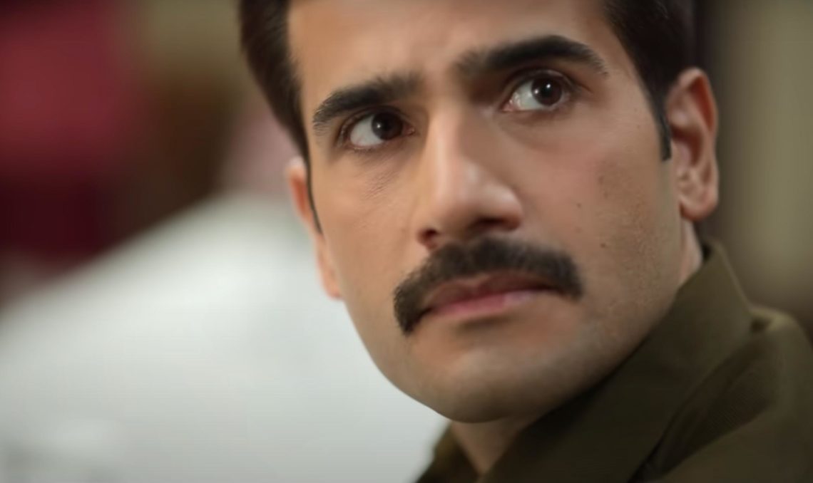 Close up of actor Karan Tacker as Indian police officer Amit Lodha looks past the camera with a concerned look on his face