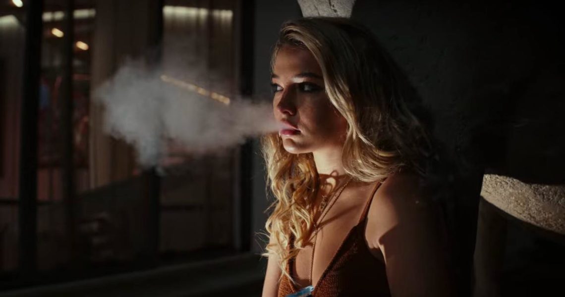 Madelyn Cline as Whiskey exhales her vape in Glass Onion