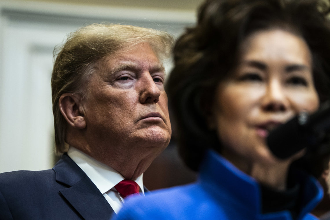 Former president Donald Trump stands behind Elaine Chao while she delivers remarks in Washington DC in 2020