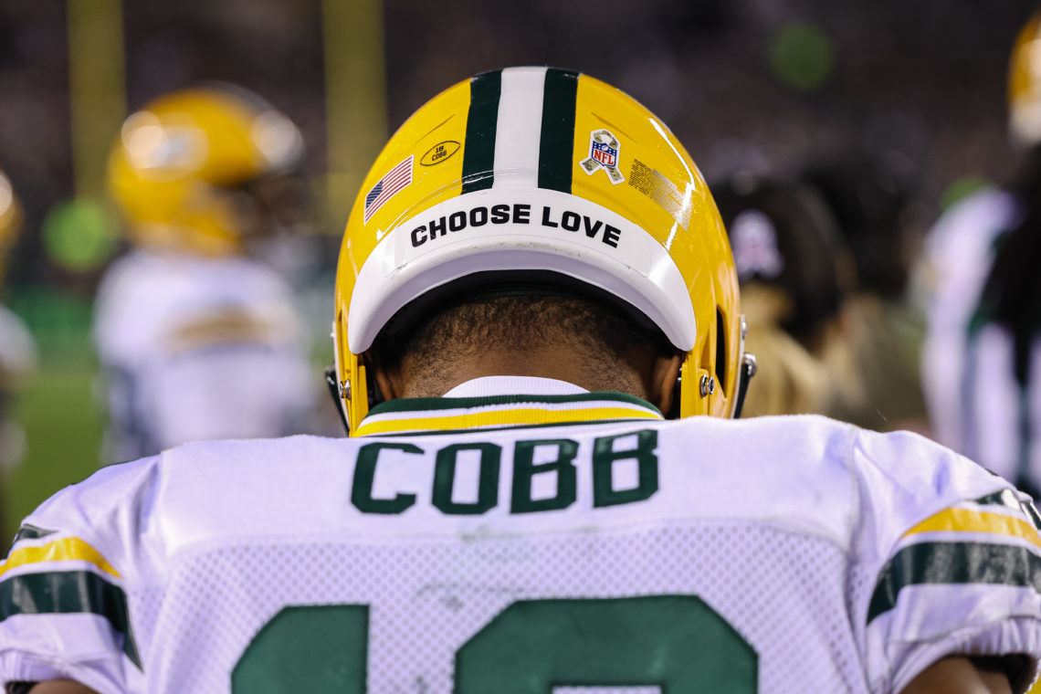 Randall Cobb #18 of the Green Bay Packers looks on with a Choose Love slogan on his helmet