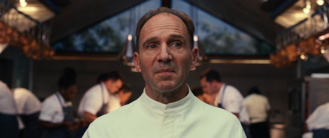 Ralph Fiennes as Hawthorne Island chef Slowik looks over restaurant while kitchen staff work behind him