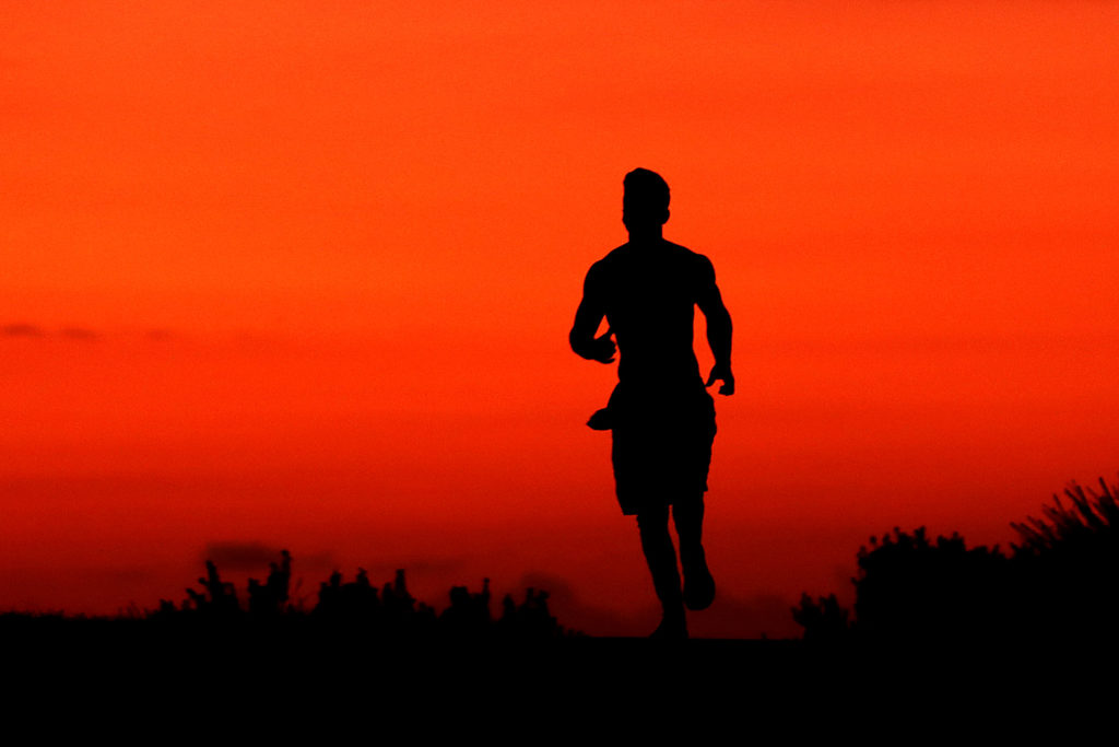 A jogger runs along the Bondi to Bronte coastal walk as the sun rises on April 01, 2020 in Sydney, Australia. The Australian government has introdu...
